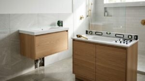 Bathroom vanity comparison and installation scene showing a floating oak vanity aligned with a green laser level alongside a freestanding timber vanity with a spirit level, measuring tape, and black cabinet pulls.