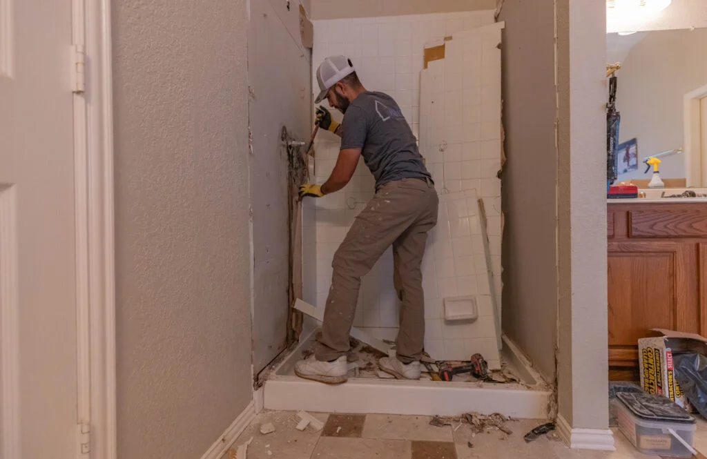 Bathroom renovation in Sydney showing hidden water damage and exposed plumbing after tile removal