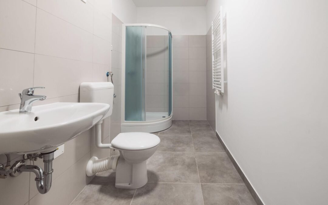 Bathroom layout showing toilet positioned next to the shower on the same wet wall with the sink placed opposite, demonstrating efficient plumbing, good clearance, and functional design for a modern bathroom renovation.