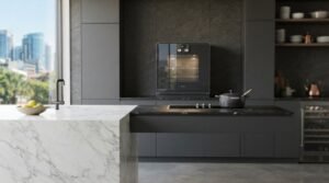 Luxury modern kitchen featuring built-in steam oven, induction hob, dark grey cabinetry, and white marble waterfall island