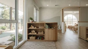 Modern childcare centre fit-out featuring natural timber furniture, open learning spaces, and large windows