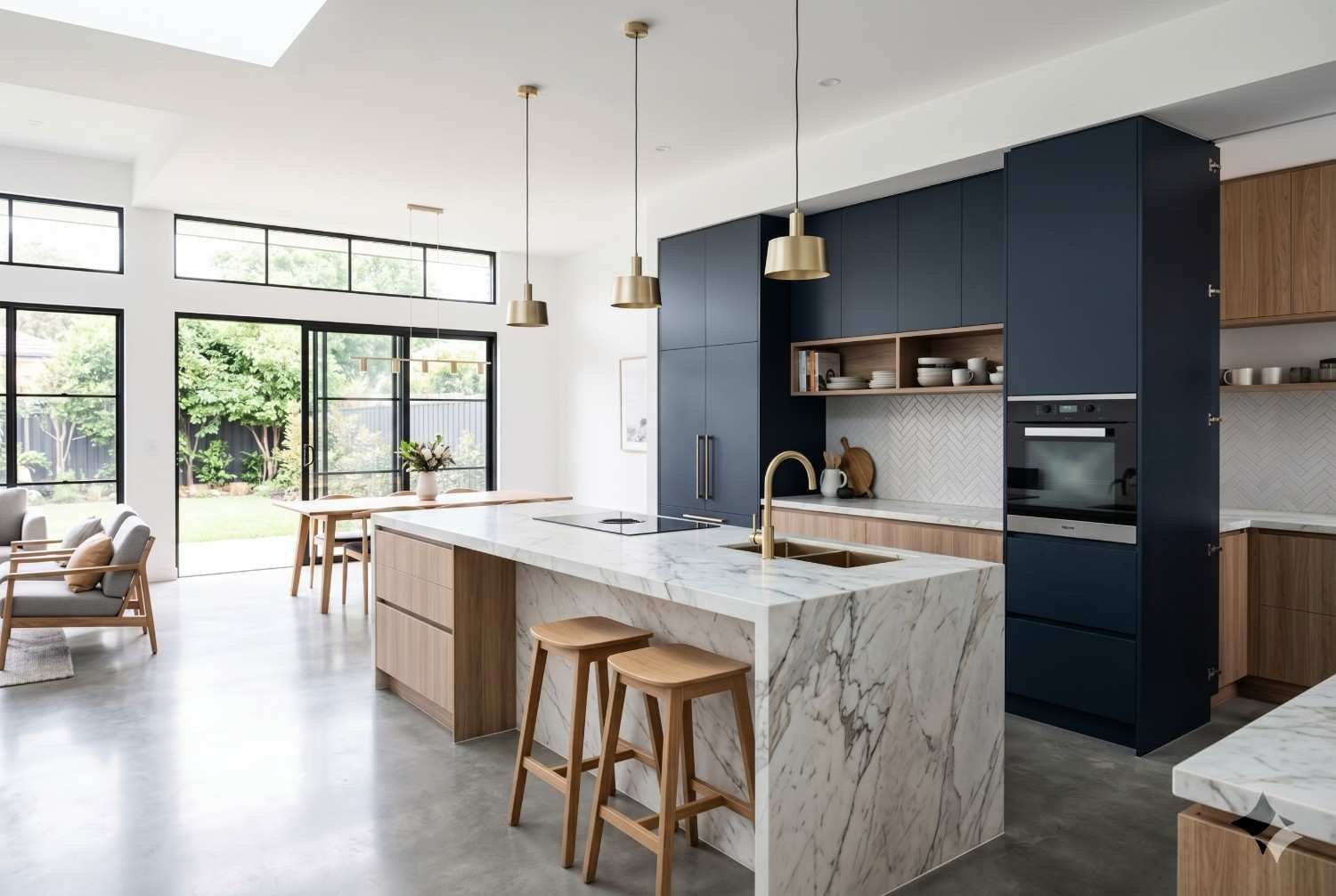 Modern kitchen renovation featuring a waterfall marble island, custom navy cabinetry, open-plan layout, polished concrete floors, and expansive glass doors. Luxury kitchen remodeling design maximizes natural light, functionality, storage, and seamless indoor-outdoor living while enhancing contemporary style and home value