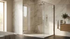 Frameless glass walk-in shower enclosure with chrome support bar, rainfall shower head, linear drain, and white marble wall tiles