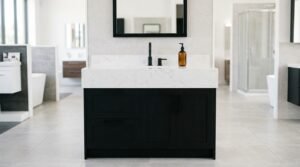 A freestanding matte black bathroom vanity featuring shaker doors and drawers, a thick white marble quartz countertop with an undermount sink, a matte black single-handle faucet, and a black-framed mirror on display in a bathroom showroom