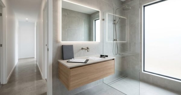 Completed Australian bathroom renovation with inspection documents and premium finishes representing the defects liability period, final handover, and builder rectification obligations in NSW.