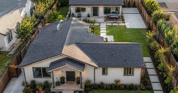 Aerial view of a suburban property with a modern detached granny flat behind the main house, featuring private outdoor space, landscaped pathways, and a well-designed layout that highlights property value and investment potential.
