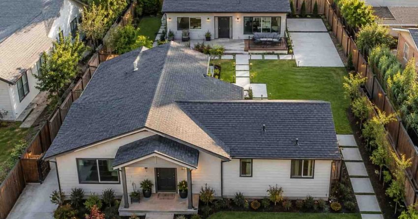 Aerial view of a suburban property with a modern detached granny flat behind the main house, featuring private outdoor space, landscaped pathways, and a well-designed layout that highlights property value and investment potential.